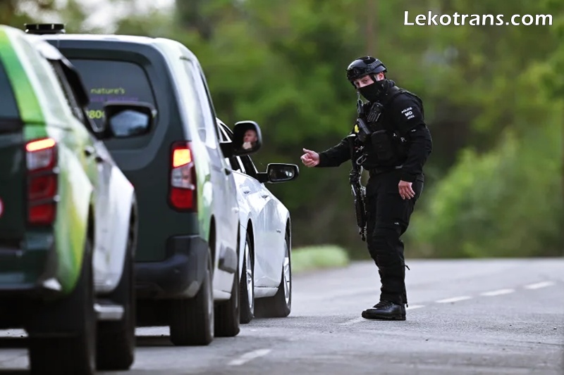Armed police maintain road blocks and security checks around RAF Fairford