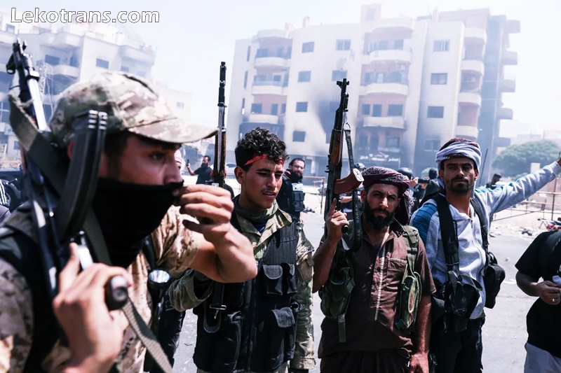 Beduin tribal fighters gather in the northern part of the city of Suwayda